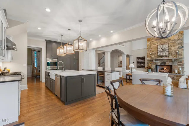 a kitchen with stainless steel appliances granite countertop a sink a stove and a wooden floors