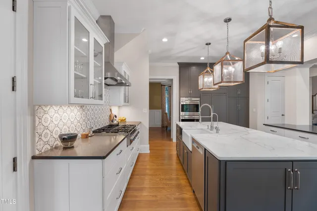 a spacious bathroom with a double vanity sink large mirror and a bathtub