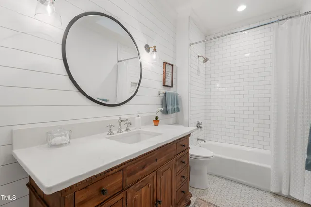 a bathroom with a sink a mirror and a window