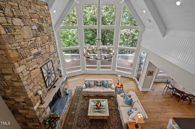 a kitchen with a sink and large windows