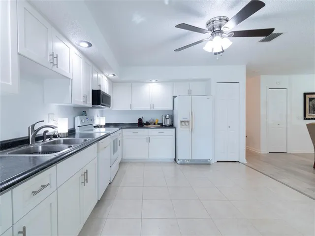 a kitchen with a sink cabinets and stainless steel appliances