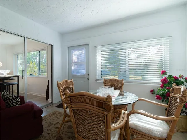 a living room with furniture and floor to ceiling window