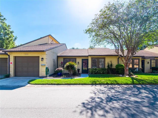 a house with green field in front of it