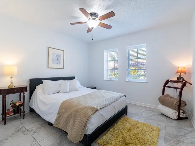 a bedroom with a bed a couch and a window