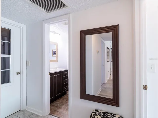 a view of a hallway view with wooden floor and closet