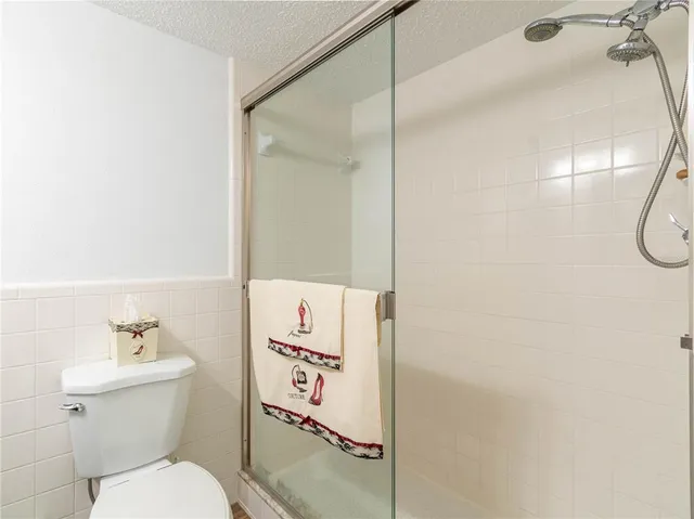 a bathroom with a toilet and a shower curtain