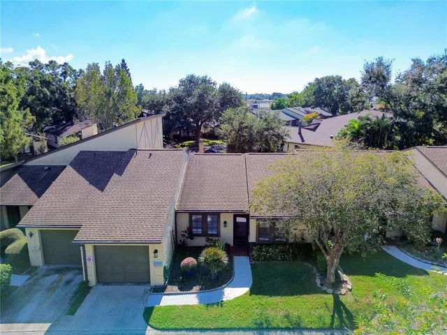 an aerial view of a house with swimming pool garden and patio