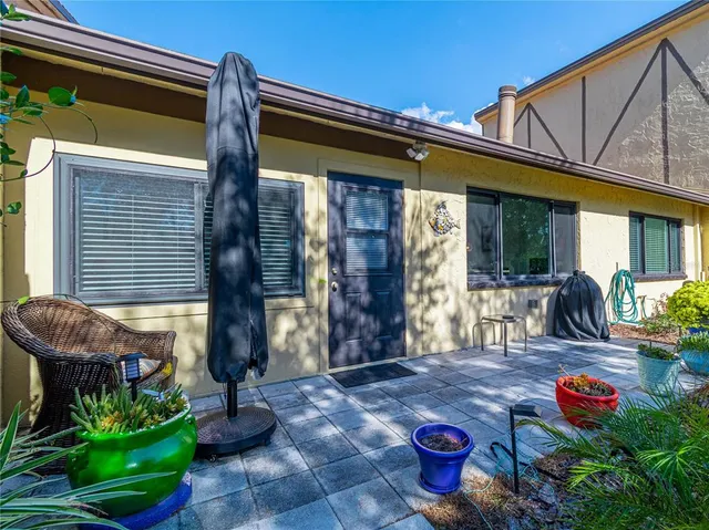 an aerial view of a residential houses with outdoor space and trees