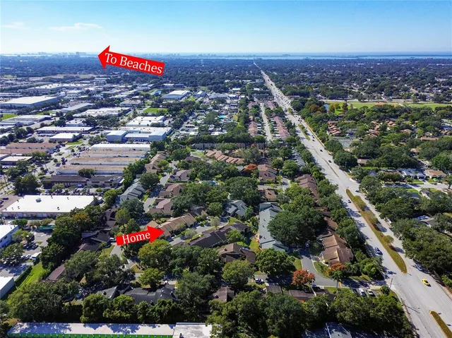 an aerial view of a house with a yard