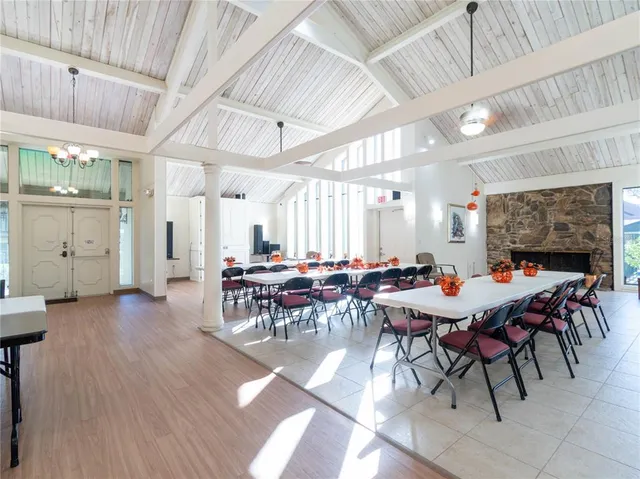 a room with pool table and windows
