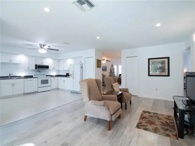 a living room with furniture and kitchen view