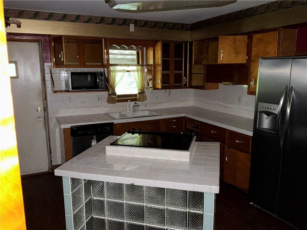 125 Webster Street Rochester, PA 15074 - Photo 9 of 15 a kitchen with a sink a counter top space and stainless steel appliances