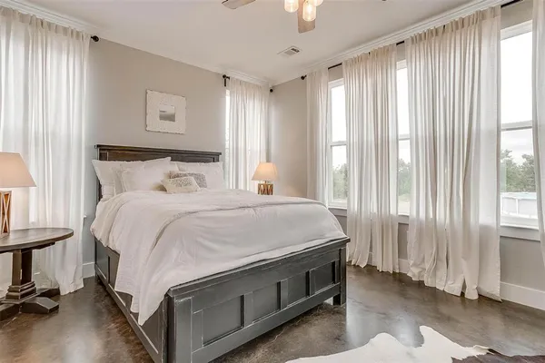 a spacious bedroom with a bed and a window