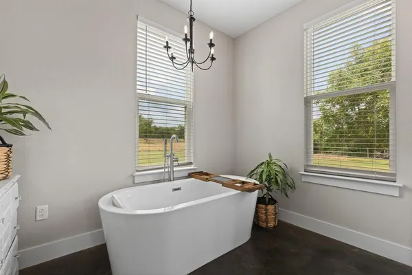 a spacious bathroom with a bathtub and window
