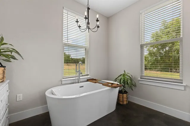 a spacious bathroom with a bathtub and window