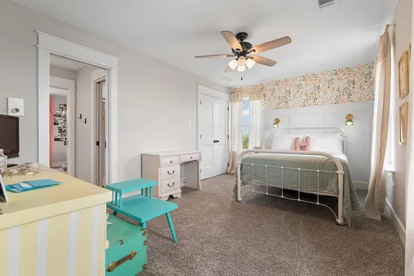 a bedroom with a bed and a chandelier
