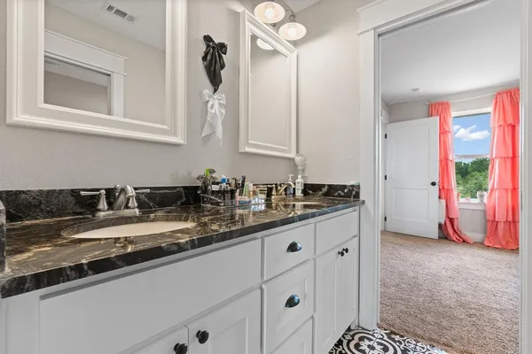 a kitchen with granite countertop a sink stainless steel appliances and cabinets