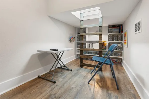 a work room with furniture and a book shelf