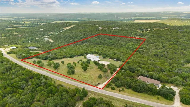 a view of a field with an ocean view