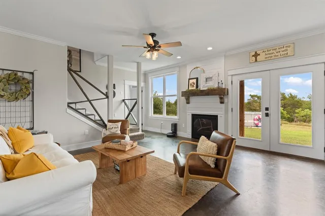 a living room with furniture a fireplace and a flat screen tv