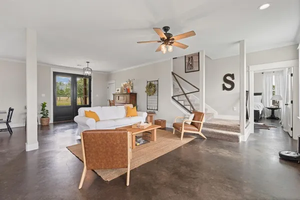 a living room with furniture and wooden floor