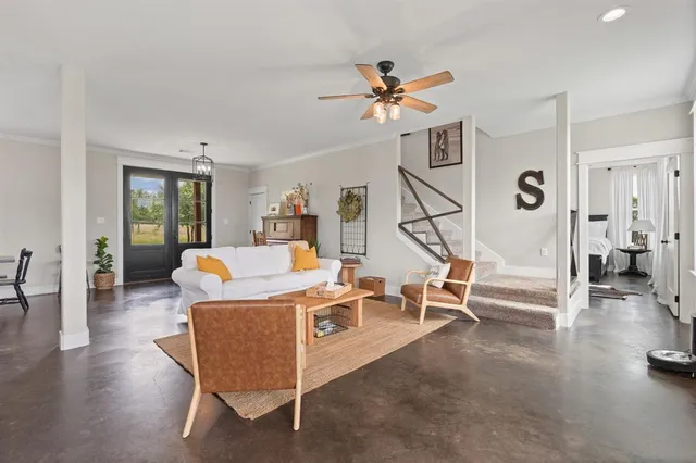 a living room with furniture and wooden floor