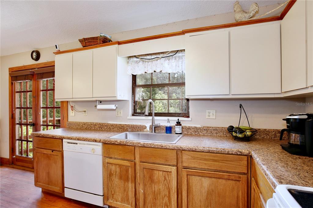 425 Mercers Fernery Road DeLand, FL 32720 - Photo 15 of 54 a kitchen with stainless steel appliances granite countertop a sink stove and cabinets