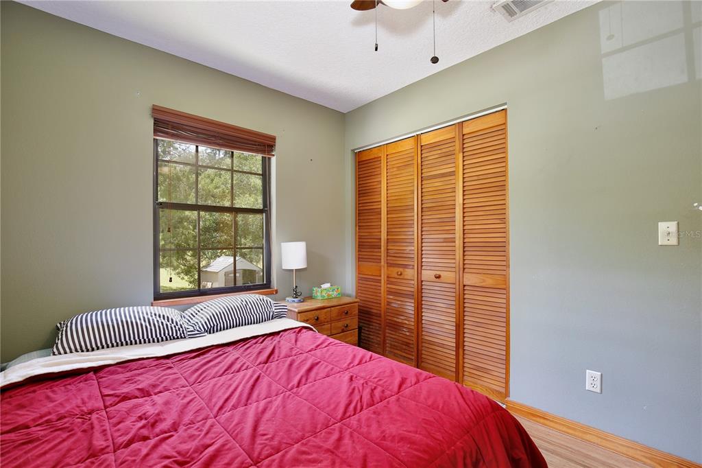 425 Mercers Fernery Road DeLand, FL 32720 - Photo 21 of 54 a bedroom with a bed and a window