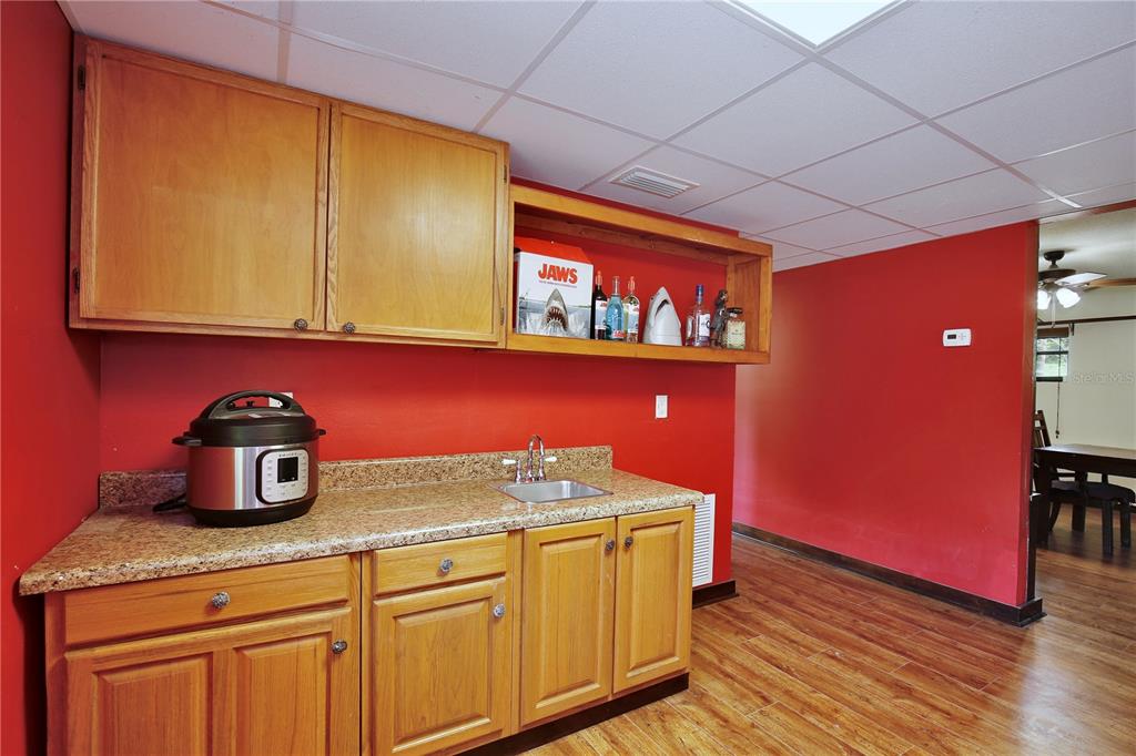 425 Mercers Fernery Road DeLand, FL 32720 - Photo 28 of 54 a kitchen with cabinets and wooden floor