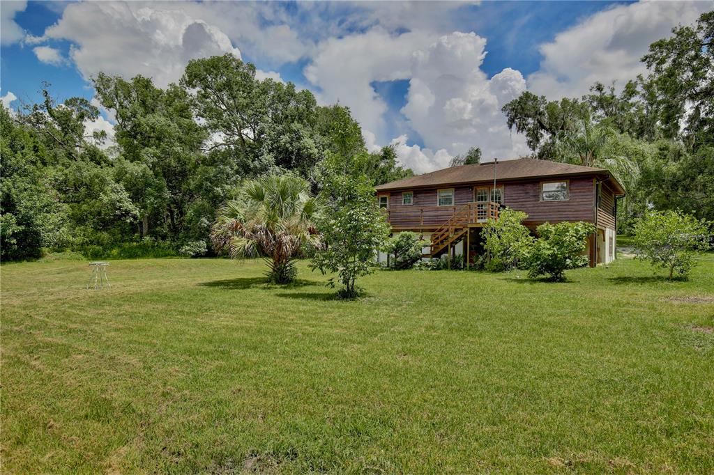 425 Mercers Fernery Road DeLand, FL 32720 - Photo 37 of 54 a view of a house with a garden