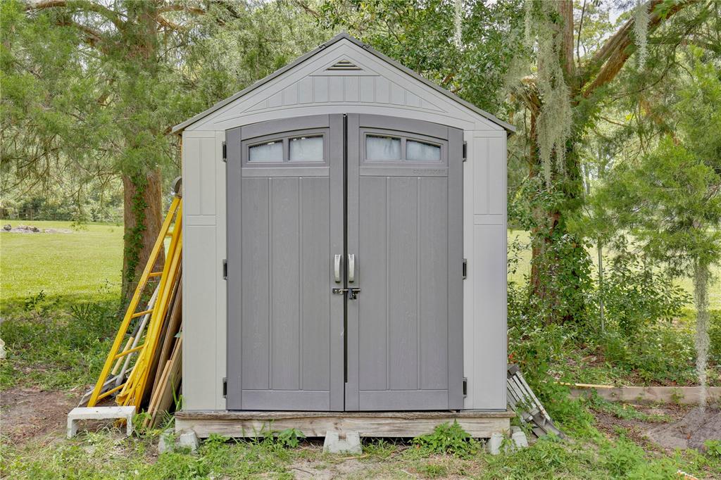 425 Mercers Fernery Road DeLand, FL 32720 - Photo 38 of 54 a front view of a house with garden