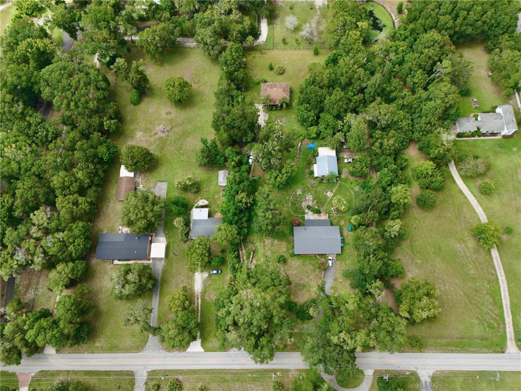 425 Mercers Fernery Road DeLand, FL 32720 - Photo 40 of 54 an aerial view of residential house with outdoor space and trees all around