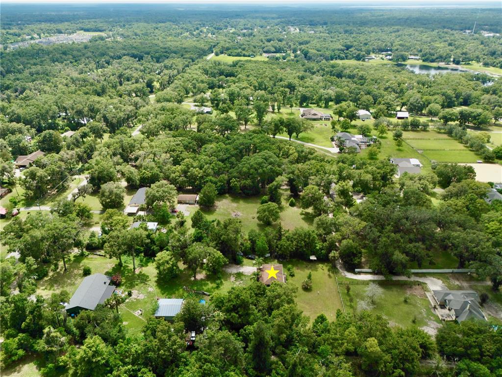 425 Mercers Fernery Road DeLand, FL 32720 - Photo 53 of 54 an aerial view of residential houses with outdoor space and trees