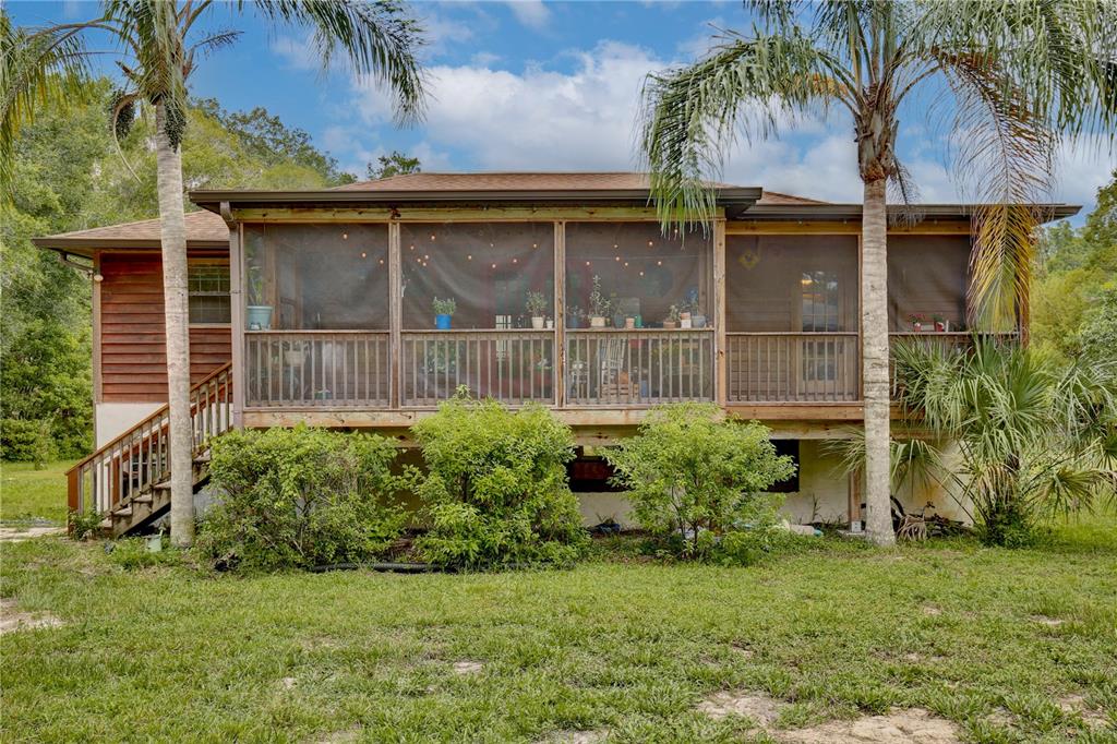 425 Mercers Fernery Road DeLand, FL 32720 - Photo 7 of 54 a house view with a garden space