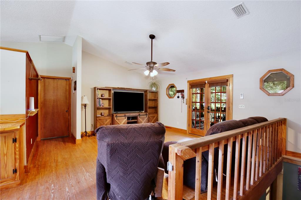425 Mercers Fernery Road DeLand, FL 32720 - Photo 8 of 54 a living room with furniture and a flat screen tv
