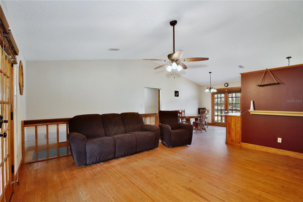 425 Mercers Fernery Road DeLand, FL 32720 - Photo 9 of 54 a living room with furniture and a wooden floor