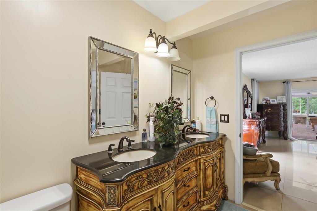 1898 Blackwelder Road De Leon Springs, FL 32130 - Photo 11 of 33 a bathroom with sinks vanity granite and a mirror