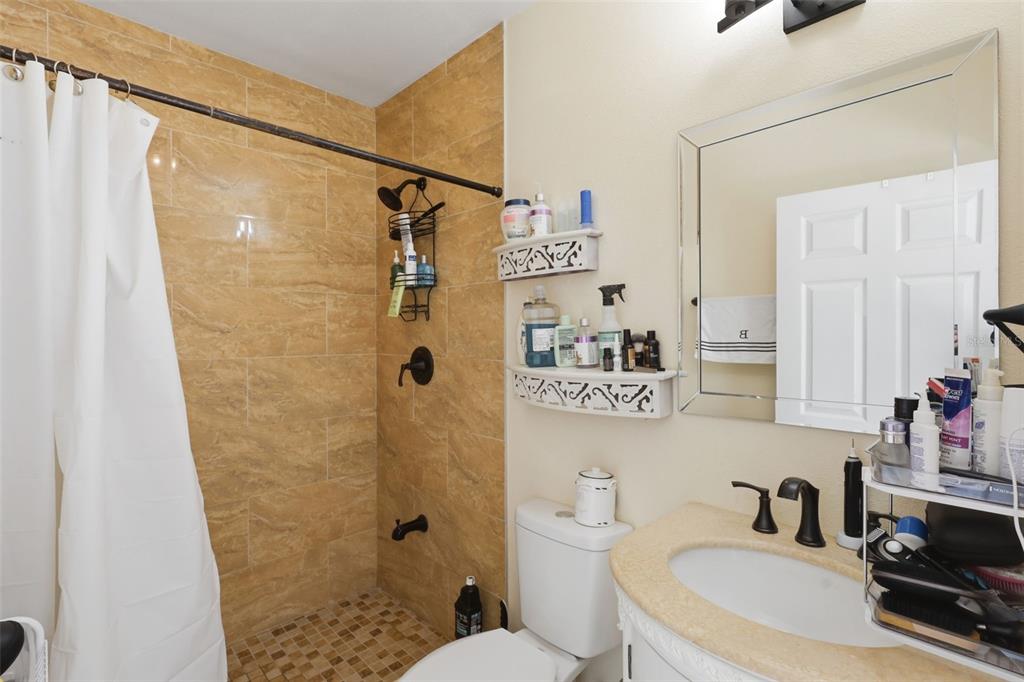 1898 Blackwelder Road De Leon Springs, FL 32130 - Photo 12 of 33 a bathroom with a sink toilet a mirror and shower