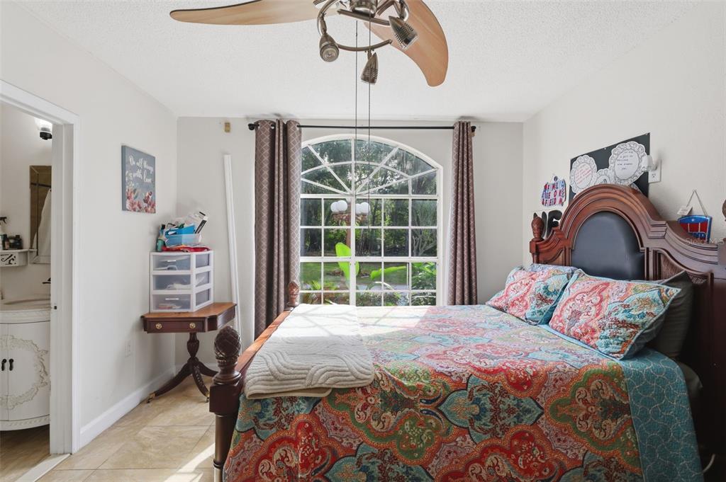 1898 Blackwelder Road De Leon Springs, FL 32130 - Photo 13 of 33 a bedroom with a bed and a chandelier