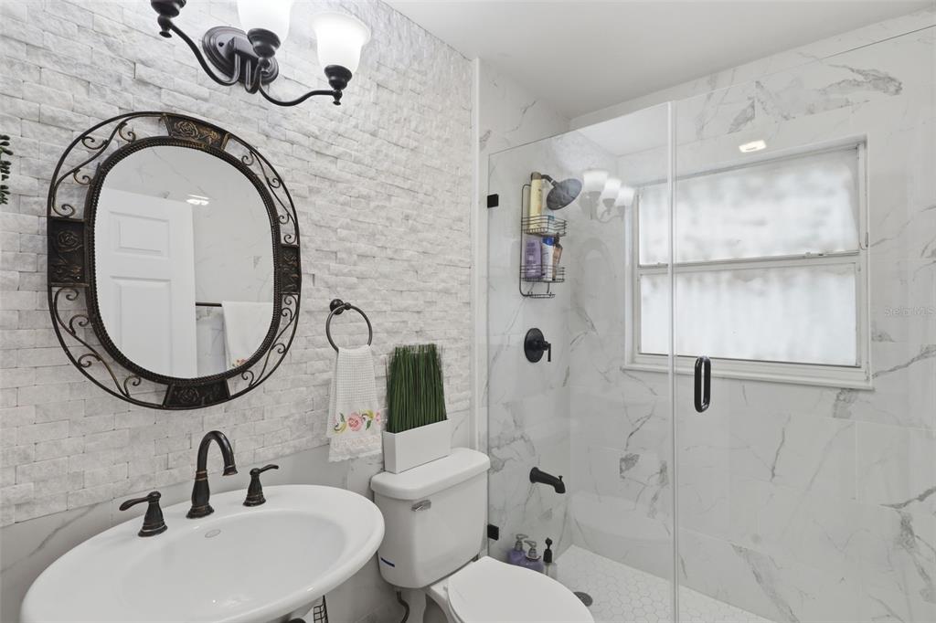 1898 Blackwelder Road De Leon Springs, FL 32130 - Photo 14 of 33 a bathroom with a toilet sink and mirror