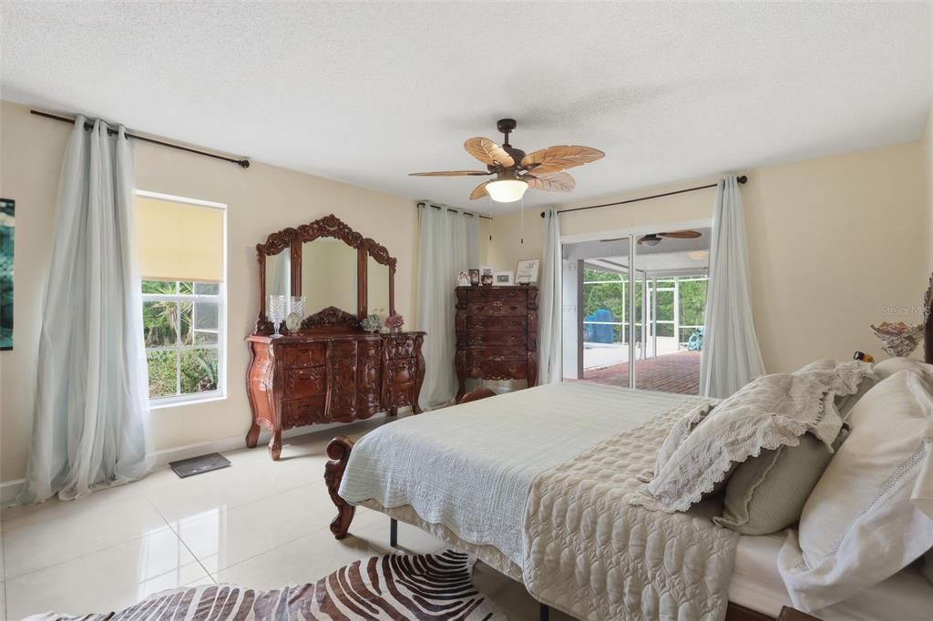 1898 Blackwelder Road De Leon Springs, FL 32130 - Photo 15 of 33 a bed room with a bed a dresser and a large window