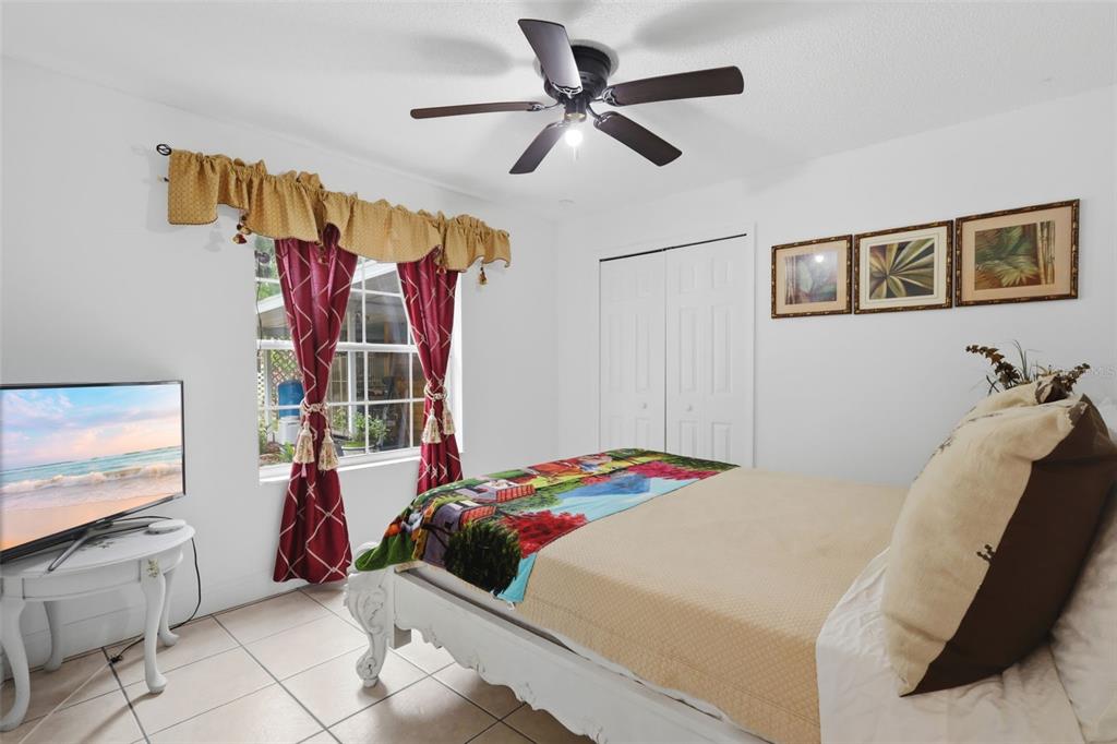 1898 Blackwelder Road De Leon Springs, FL 32130 - Photo 17 of 33 a bedroom with a bed and a chandelier