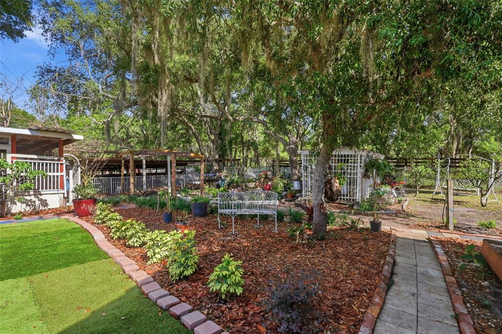 1898 Blackwelder Road De Leon Springs, FL 32130 - Photo 18 of 33 a view of a garden with a patio