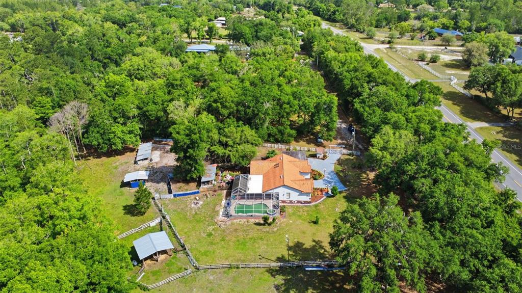 1898 Blackwelder Road De Leon Springs, FL 32130 - Photo 27 of 33 an aerial view of a house with swimming pool and garden