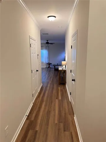 a view of a room with wooden floor