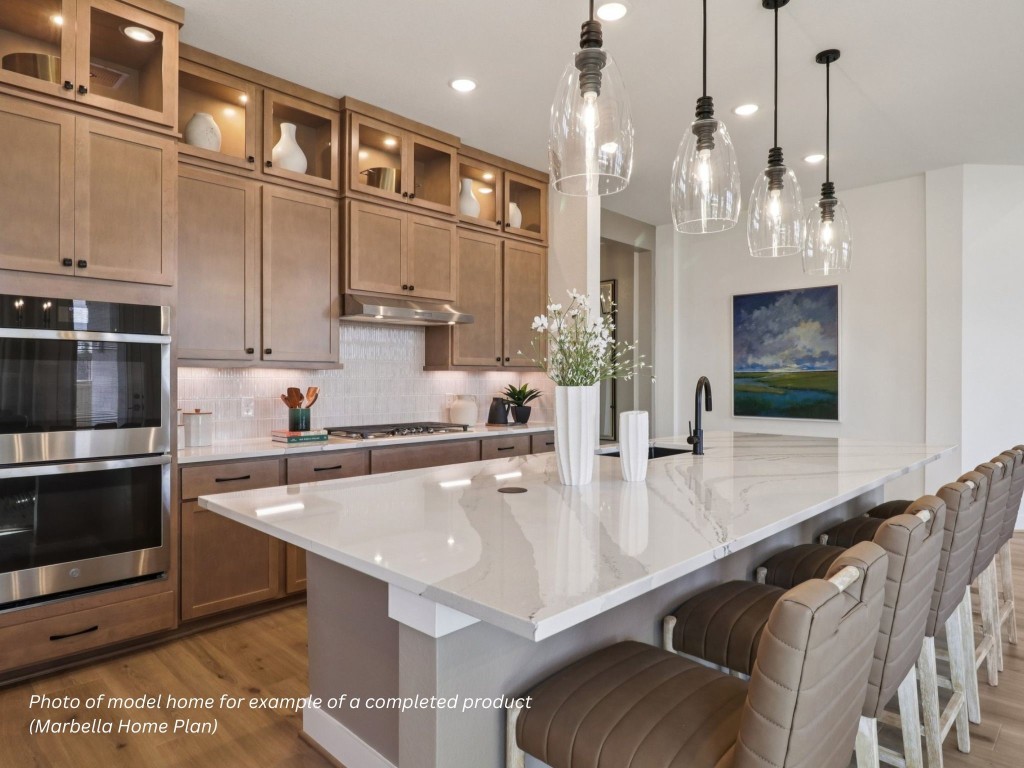 16843 Deep Wingbeat Way Magnolia, TX 77354 - Photo 3 of 12 a large kitchen with stainless steel appliances a large counter top