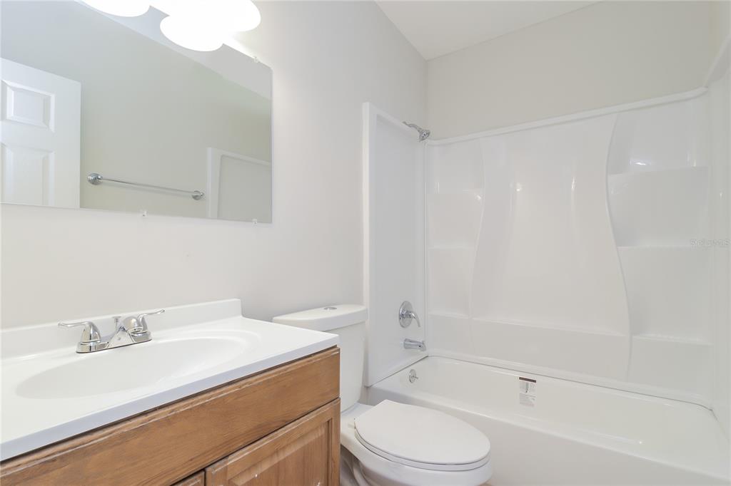 11623 Cameron Street Orlando, FL 32817 - Photo 13 of 16 a bathroom with a sink a toilet and a bathtub