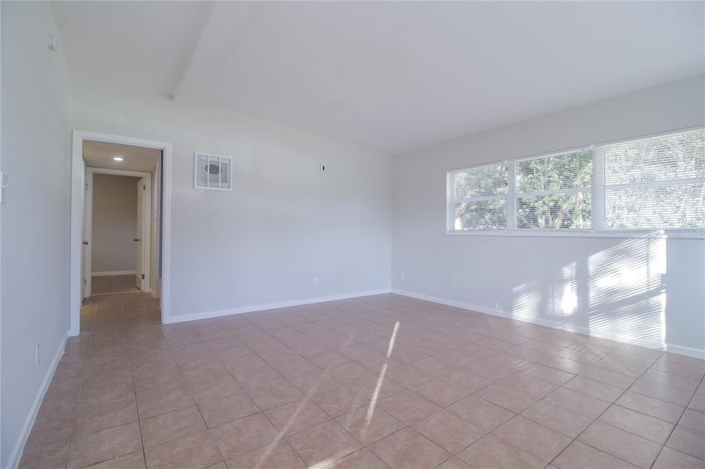 11623 Cameron Street Orlando, FL 32817 - Photo 4 of 16 an empty room with windows and yard