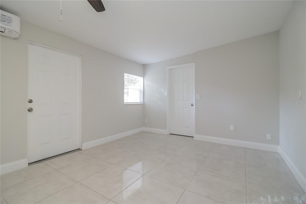 11623 Cameron Street Orlando, FL 32817 - Photo 7 of 16 a view of an empty room with a window