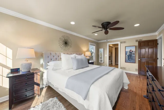 a spacious bedroom with a bed and a chandelier